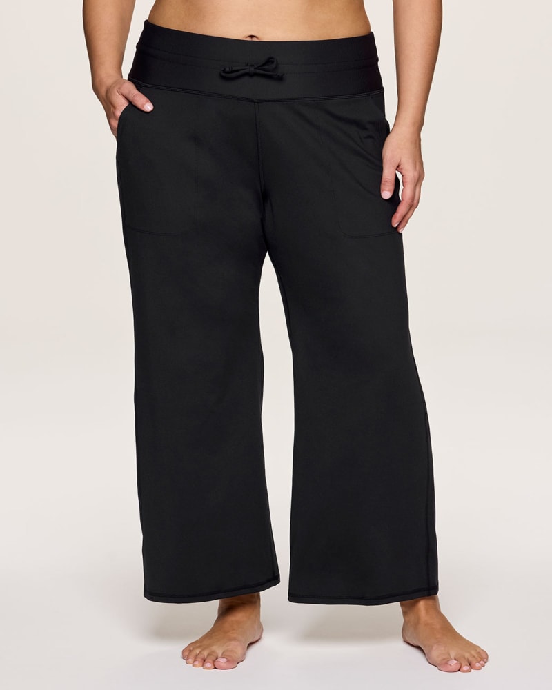 Front of a model wearing a size 1X Plus Super Soft Everyday Wide Leg Pant in Black by RBX Active. | dia_product_style_image_id:347009